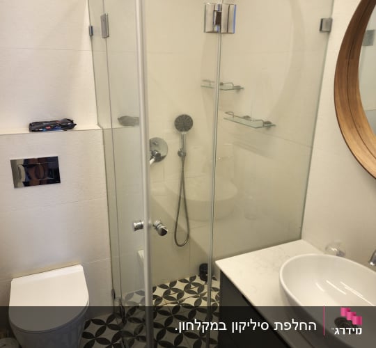 מקלחון זכוכית עם ראש מקלחת ומדפים